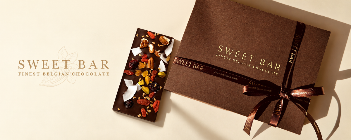 Banner de Sweet Bar con caja de regalo marrón y tableta de chocolate con frutos secos y frutas sobre fondo marfil, sin la sombra superior.